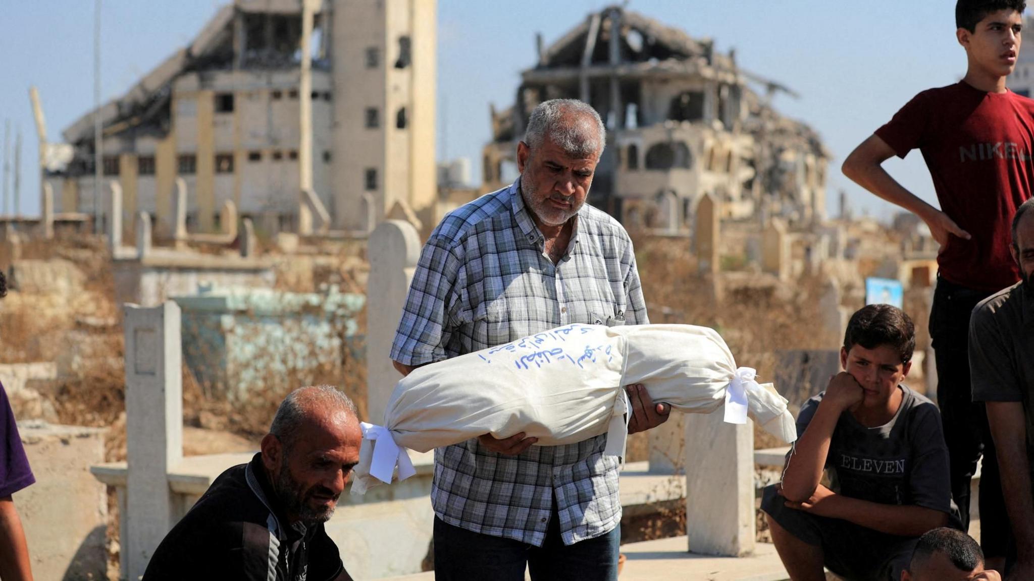 Israeli drone strike kills 12 people, including a family of six in Gaza