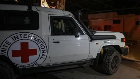 Hamas Transfers Two Bodies of Deceased Hostages to Israel Amid Ongoing Tensions