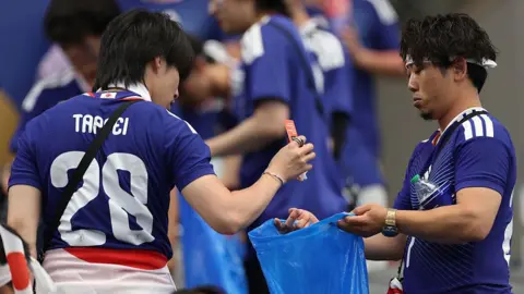 Japanese Fans Clean Stadiums After World Cup, Spark Debate Over Home Duties