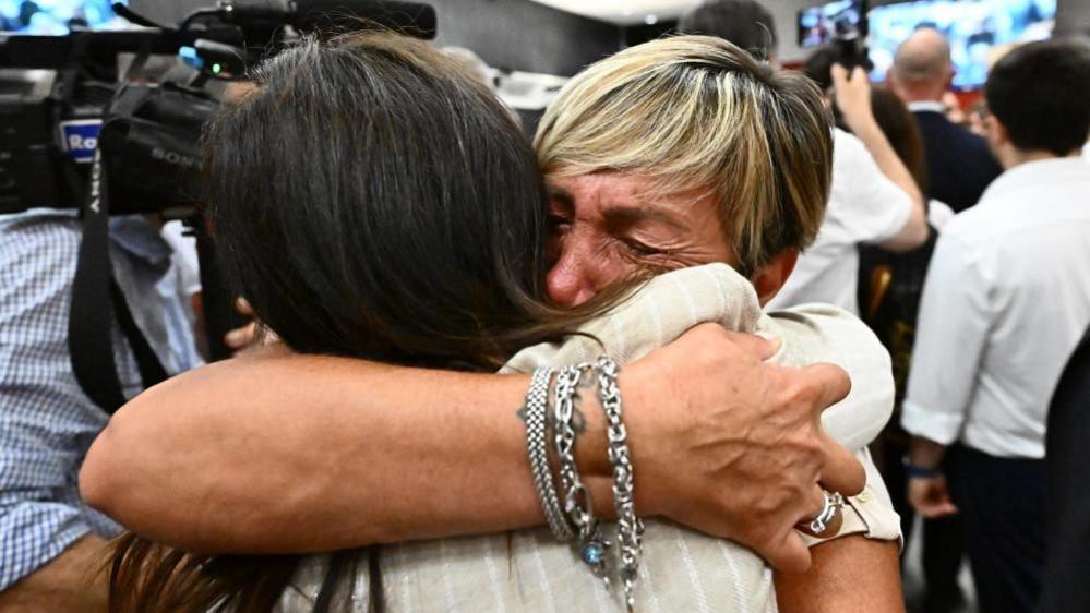 Relatives of victims hugging after verdict