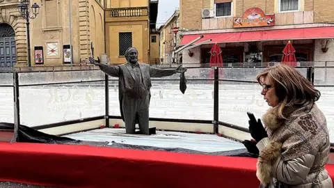 Controversy Erupts as Pavarotti Statue Encased in Ice Rink in Italy